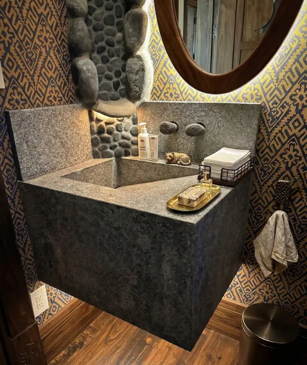 Custom stone vanity with river rock accents